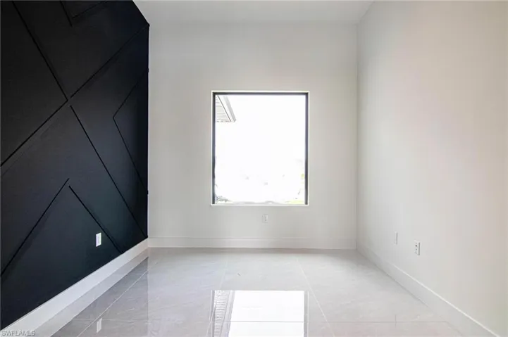 Spare room featuring baseboards