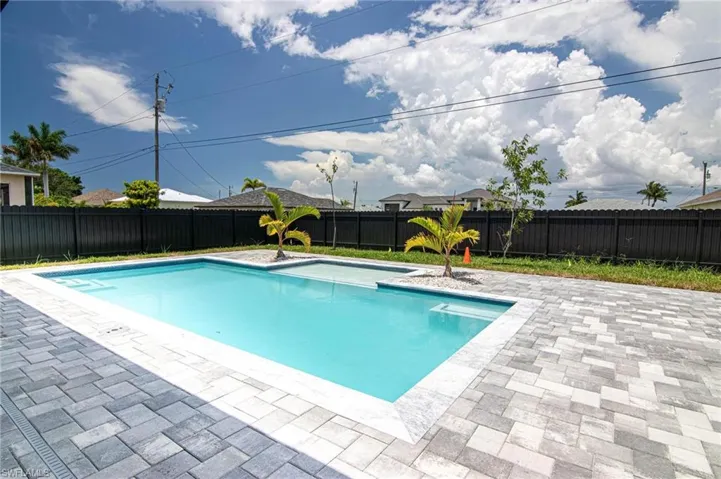 View of swimming pool with a patio and a fenced backyard