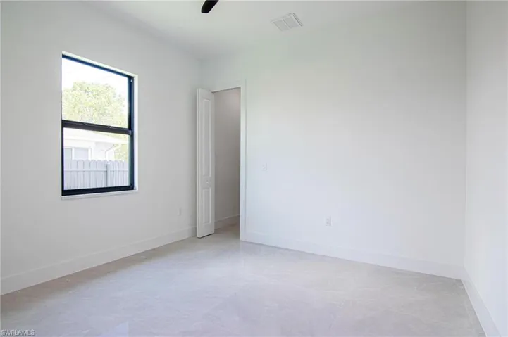 Empty room featuring baseboards and ceiling fan