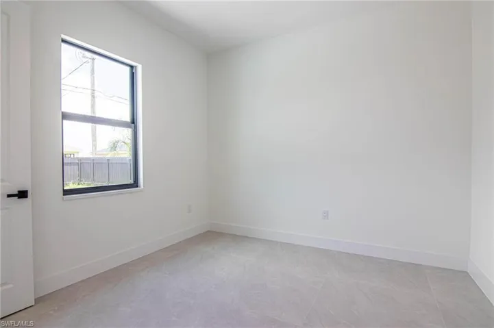 Unfurnished room with baseboards