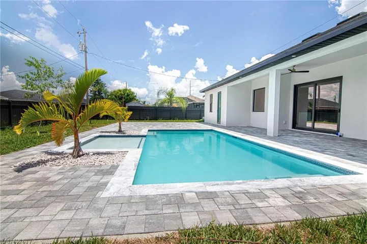 View of swimming pool with a fenced backyard, a patio, and a ceiling fan