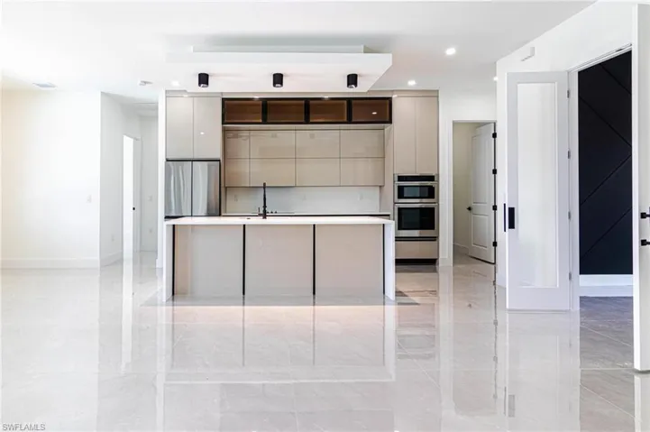 Kitchen featuring modern cabinets, a center island, light countertops, recessed lighting, and stainless steel appliances