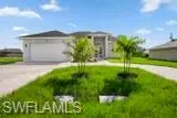 View of front of home with a garage and a front lawn