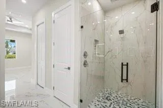 Bathroom with walk in shower and tile flooring