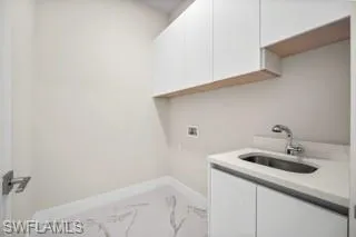 Laundry area featuring hookup for a washing machine and sink