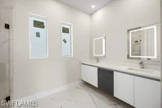 Bathroom featuring dual bowl vanity