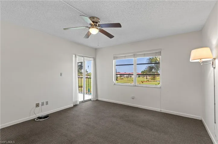 Master bedroom with sliding glass door to screened lanai