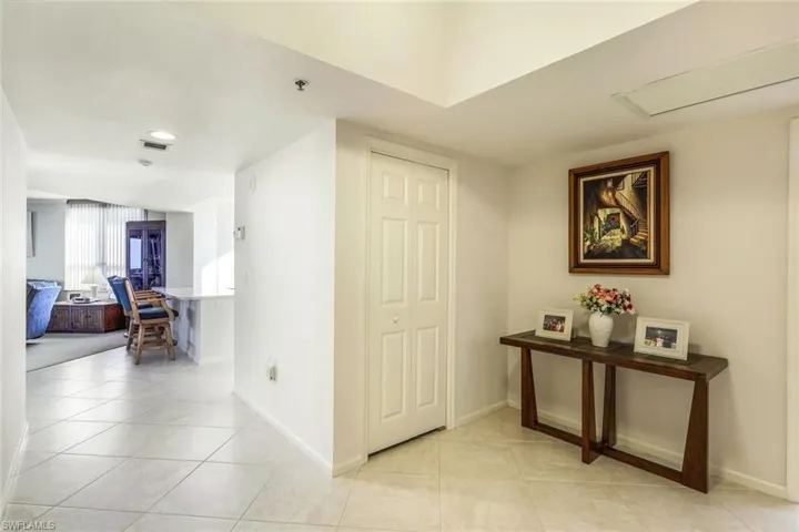 Hallway featuring light tile patterned floors