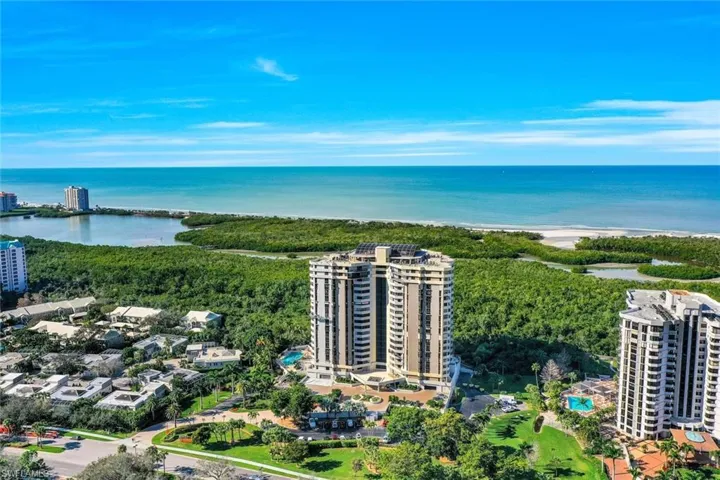 Birds eye view of property with a water view