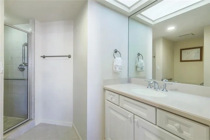 Bathroom featuring vanity, tile patterned floors, and an enclosed shower