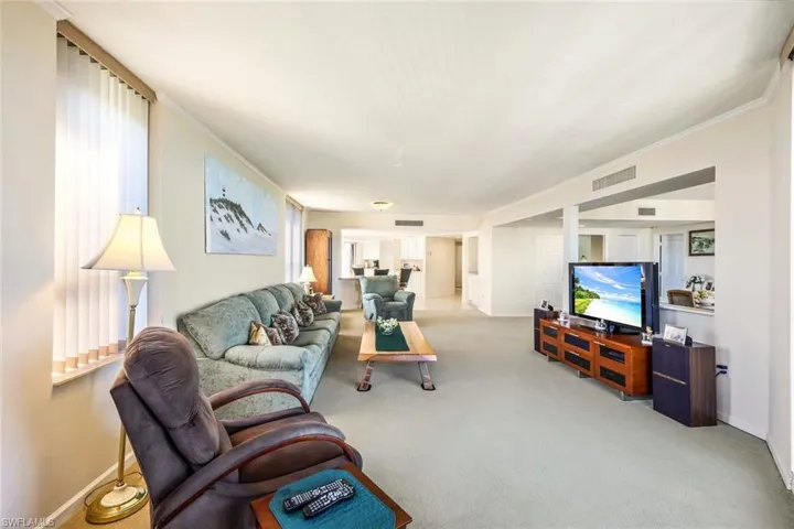 Living room with carpet and ornamental molding