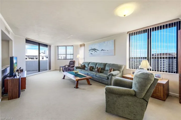 Living room with light carpet and crown molding