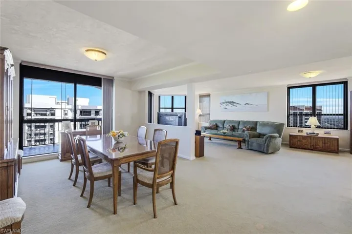 Carpeted dining space with a wall of windows and plenty of natural light