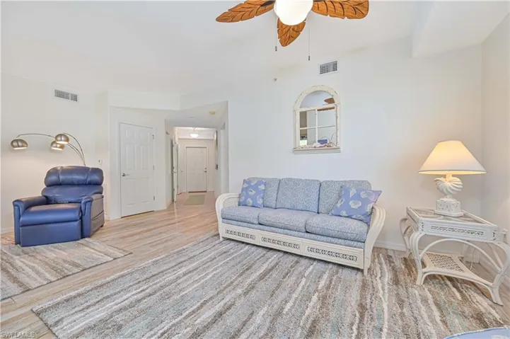 Living area featuring wood finished floors and a ceiling fan
