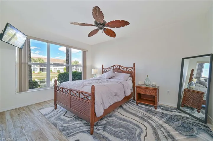 Bedroom with wood finished floors and a ceiling fan