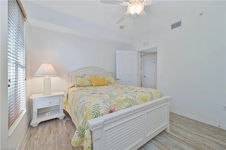 Bedroom with a ceiling fan and light wood-type flooring