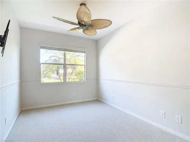 Unfurnished room with ceiling fan and carpet floors