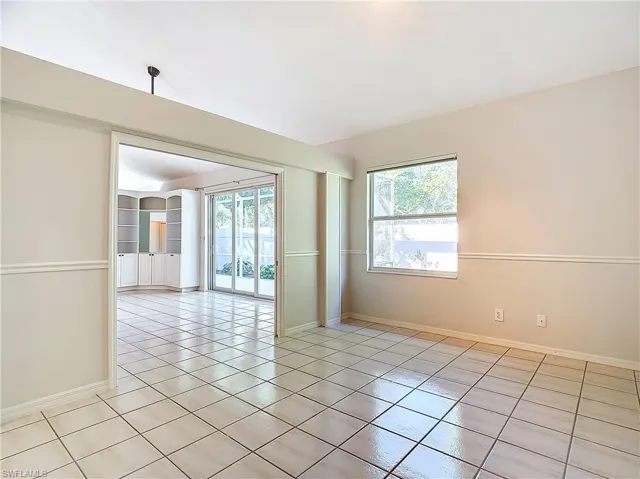 Unfurnished room with light tile flooring