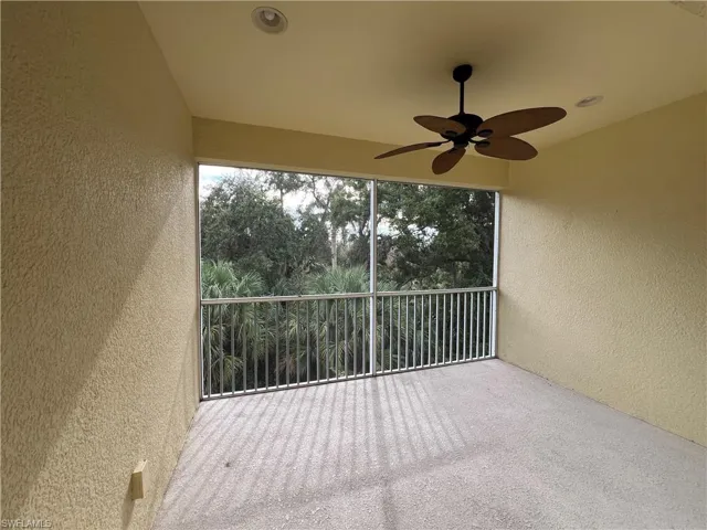Unfurnished sunroom with ceiling fan