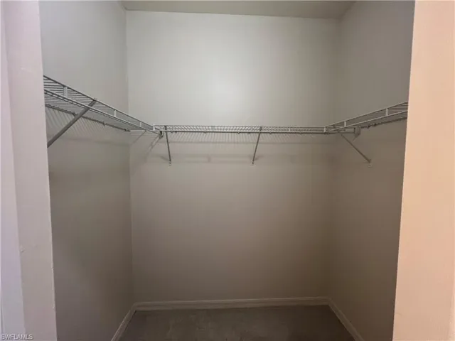 View of one of two master walk in closets