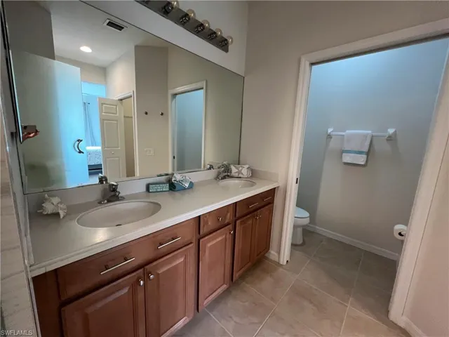 Master Bathroom featuring vanity, toilet, and tile patterned flooring