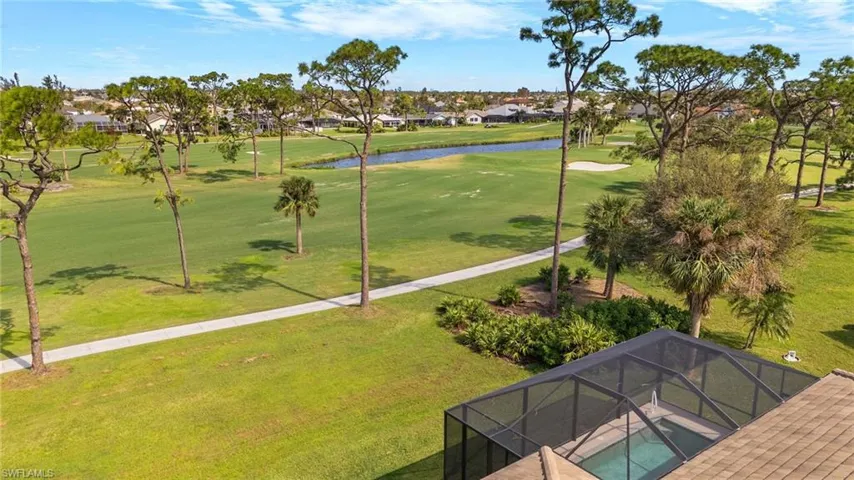 View of community featuring a lawn and a swimming pool