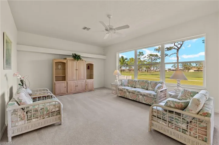 Living room featuring ceiling fan and light colored carpet