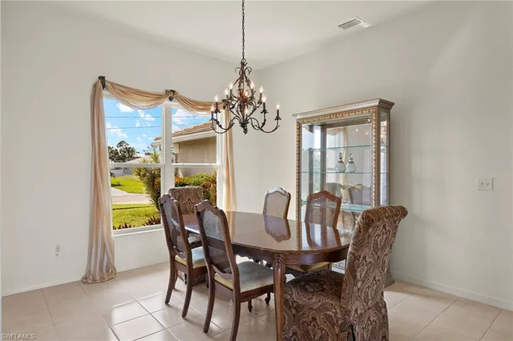 Dining area featuring an inviting chandelier and light tile patterned flooring