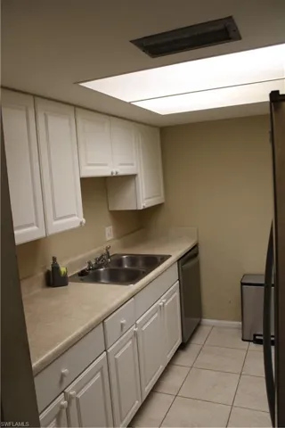 Kitchen featuring white cabinets, sink, and dishwasher