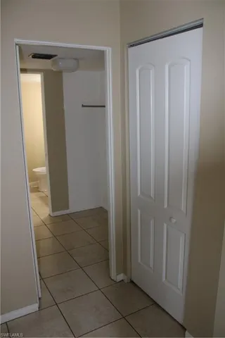 Hallway with light tile patterned floors