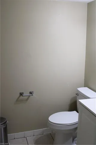 Bathroom with vanity, tile patterned flooring, and toilet
