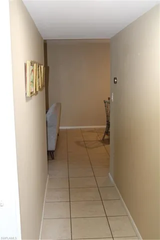 Corridor with light tile patterned flooring
