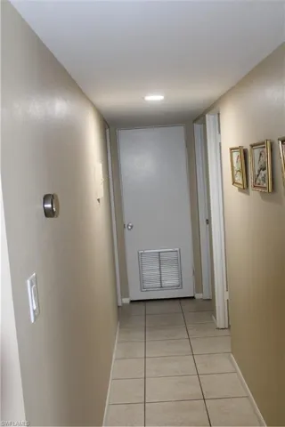 Corridor with light tile patterned floors