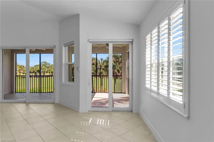 Doorway featuring tile patterned flooring and baseboards