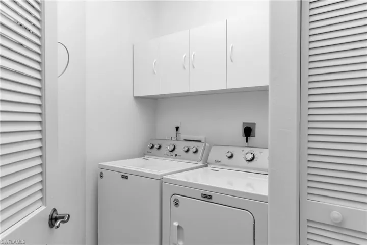 Laundry room featuring cabinet space and washer and dryer.