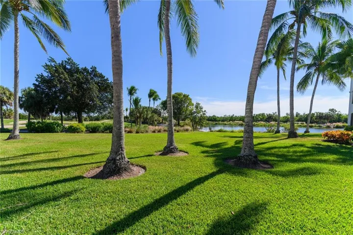 Scenic water views just outside the unit are framed by manicured lawns and tropical surroundings.
