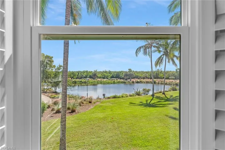 Water view with a tree filled landscape.