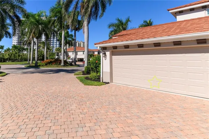 Garage featuring decorative driveway.