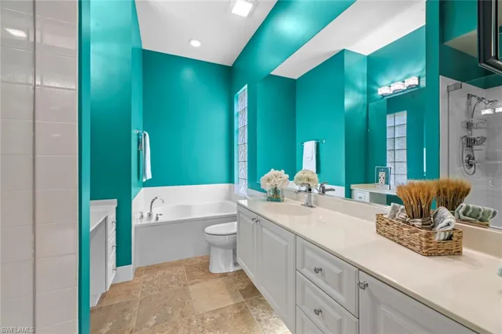 Full bath with toilet, shower / bath combo, vanity, and tile patterned flooring