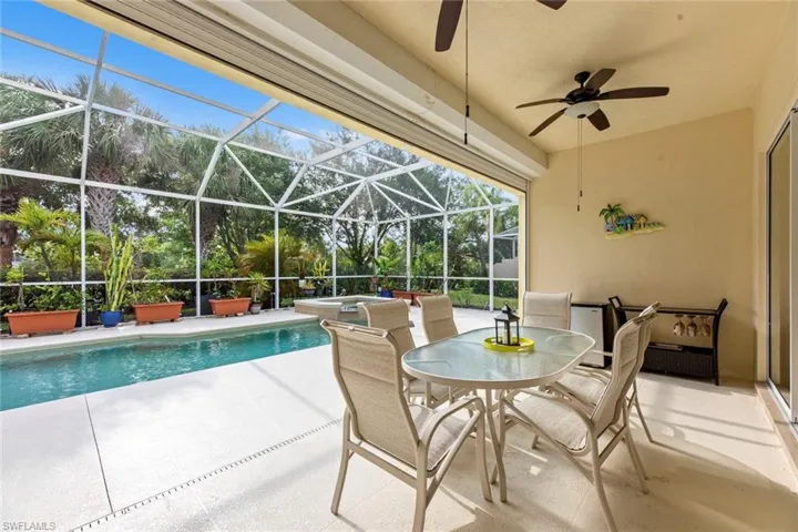 View of swimming pool featuring a patio area, a lanai, and a pool with connected hot tub