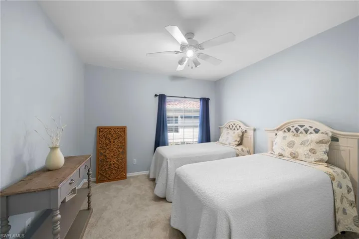 Bedroom 2 with ceiling fan and newer carpeting