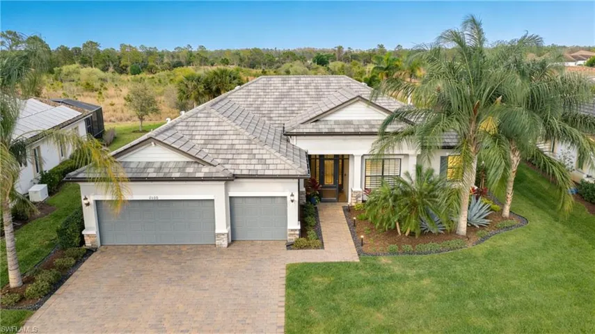 Situated on a .38 acre executive lot with miles of private preserve