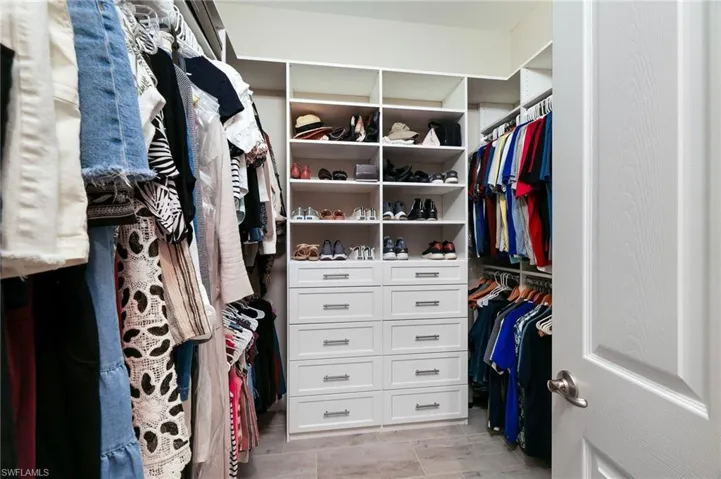 Primary walk-in closet with custom built-in storage