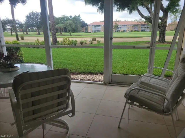 Screened lanai with storm shutters facing south overlooking golf course.