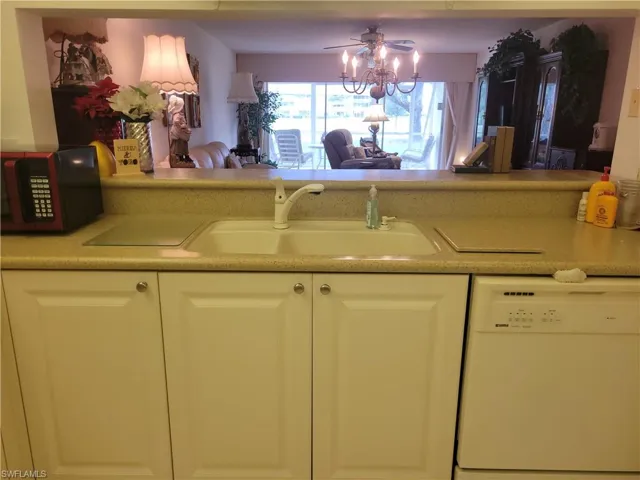 Kitchen with corian counters open to snack bar and dining room.
