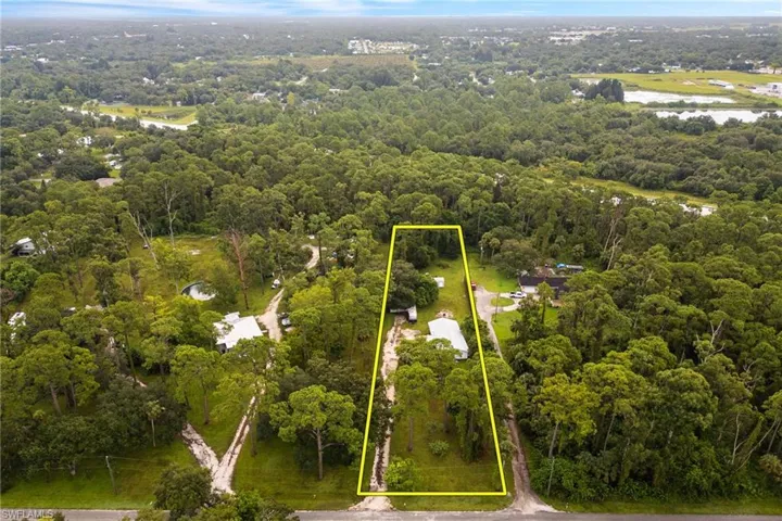 Aerial view of property's location with a large body of water and property boundaries highlighted
