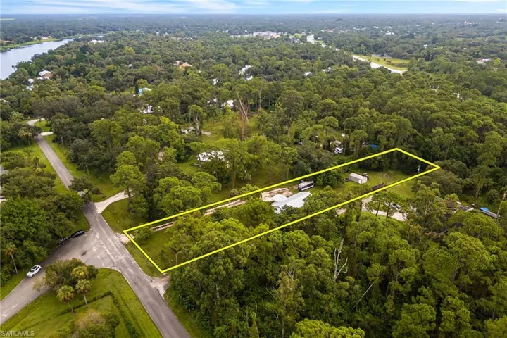 View of property location with property parcel outlined and a nearby body of water