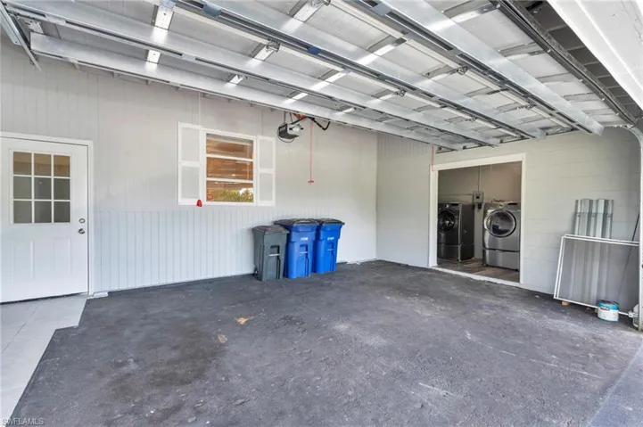 Garage featuring a garage door opener and washer and clothes dryer