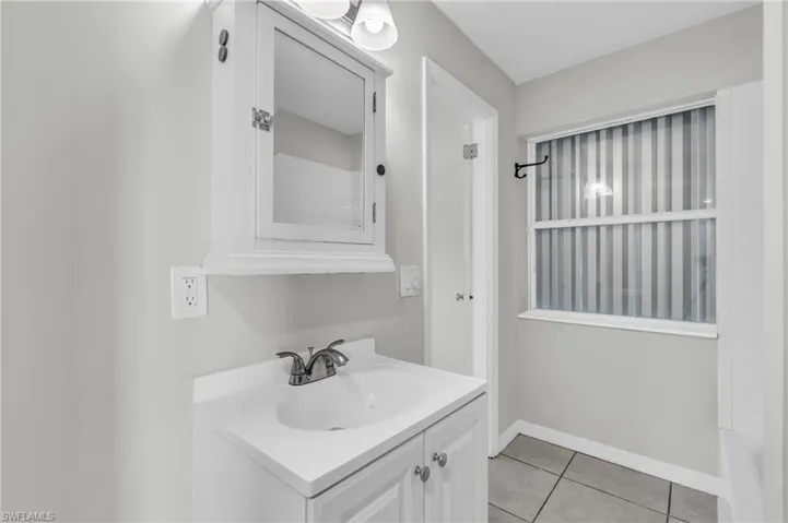 Bathroom with vanity, plus walk in shower, and tile patterned floors