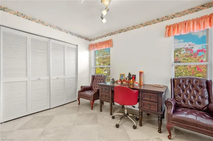 Office area with track lighting and light tile flooring